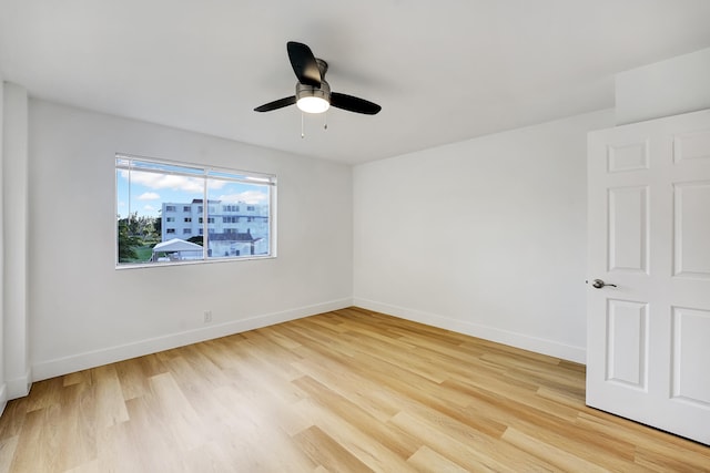 spare room featuring light hardwood / wood-style flooring and ceiling fan