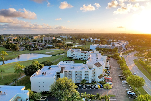 aerial view at dusk featuring a water view