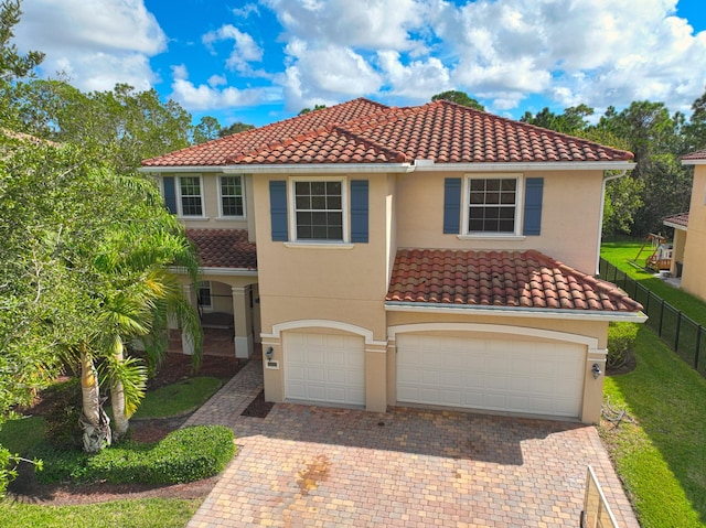 mediterranean / spanish-style home featuring a garage