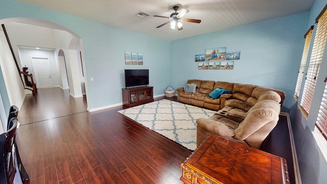 living room featuring dark hardwood / wood-style flooring and ceiling fan