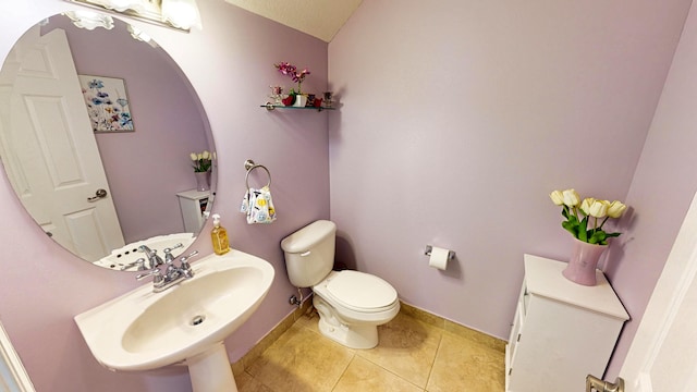 bathroom featuring tile patterned flooring and toilet