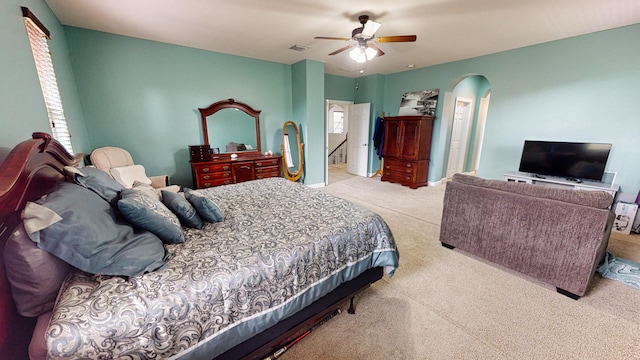 bedroom with ceiling fan and light colored carpet