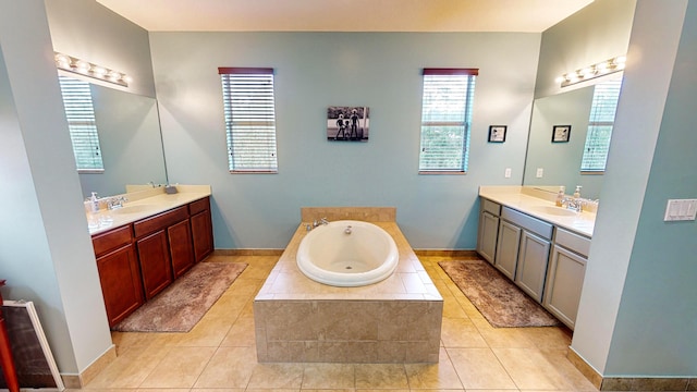 bathroom featuring tiled bath, tile patterned flooring, and vanity