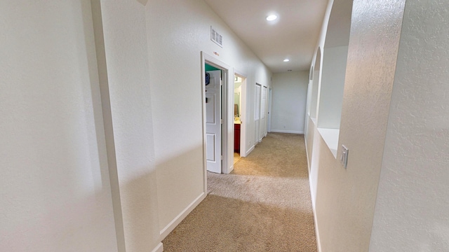 corridor with light colored carpet