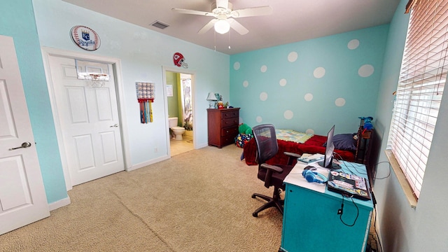 carpeted office space featuring ceiling fan