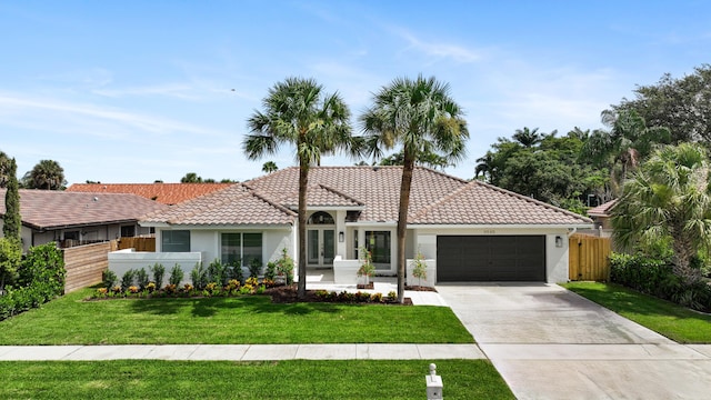 view of front of property with a front lawn and a garage