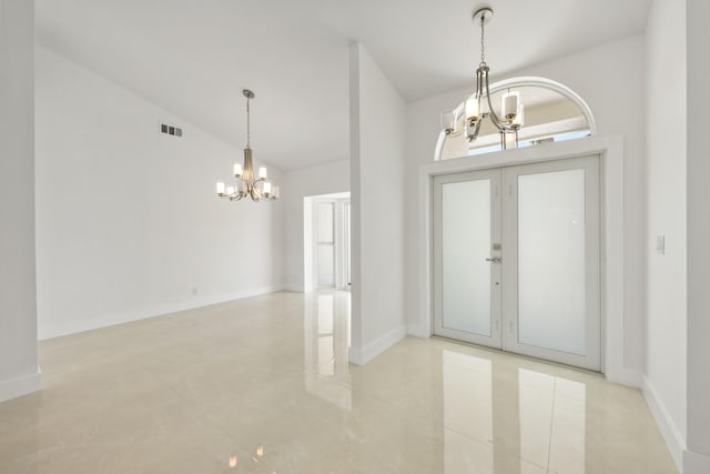 entryway featuring light tile patterned flooring, french doors, high vaulted ceiling, and a chandelier