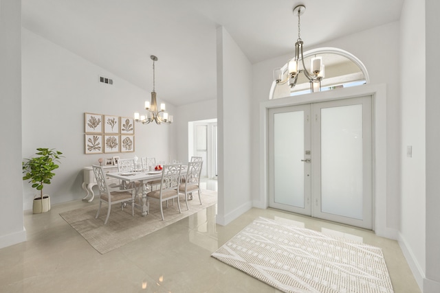 entryway featuring a notable chandelier and high vaulted ceiling