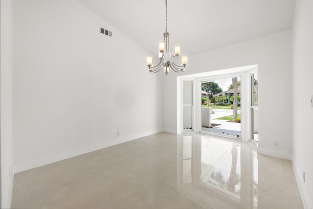 empty room featuring a chandelier and lofted ceiling