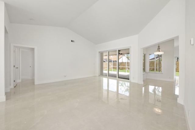 unfurnished room with high vaulted ceiling