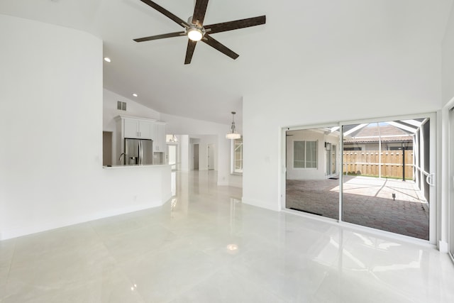 spare room with ceiling fan and high vaulted ceiling