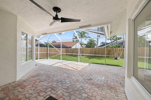 view of patio / terrace with ceiling fan and glass enclosure