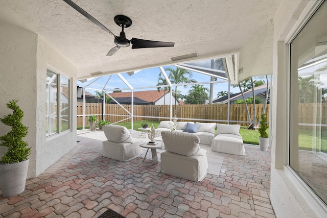 view of patio featuring an outdoor living space, ceiling fan, and a lanai