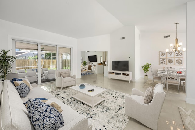 empty room with lofted ceiling and a notable chandelier