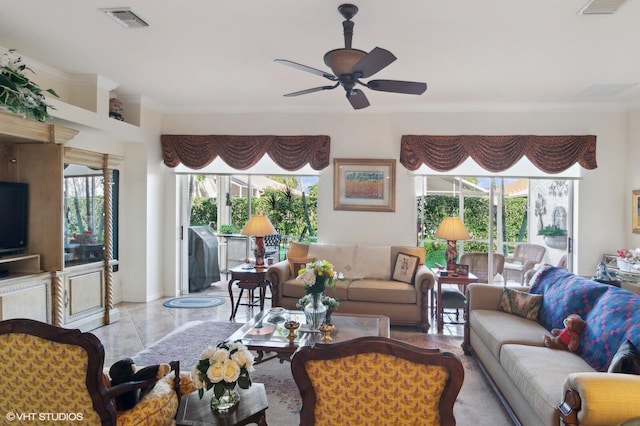 living room with ceiling fan and ornamental molding