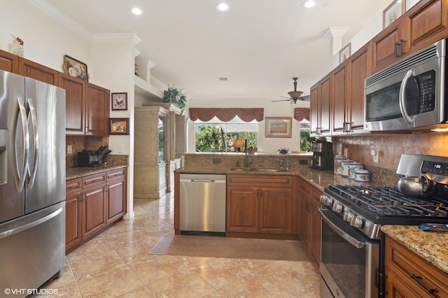 kitchen featuring backsplash, dark stone countertops, ceiling fan, and appliances with stainless steel finishes