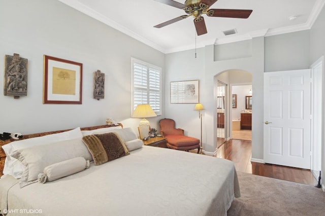 bedroom with ensuite bath, ceiling fan, crown molding, and hardwood / wood-style flooring