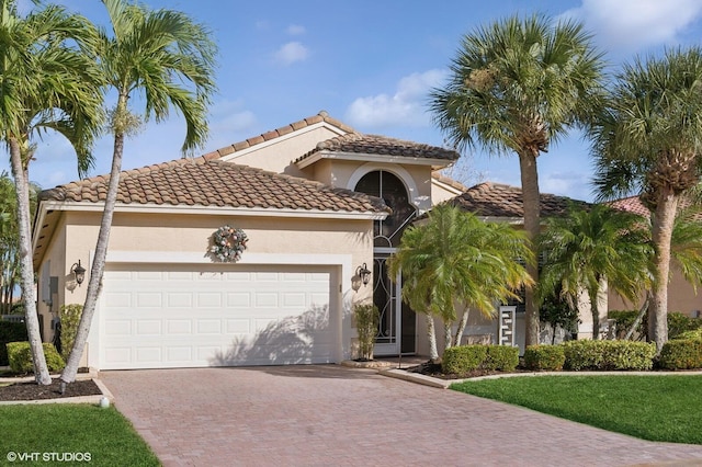 mediterranean / spanish house with a garage