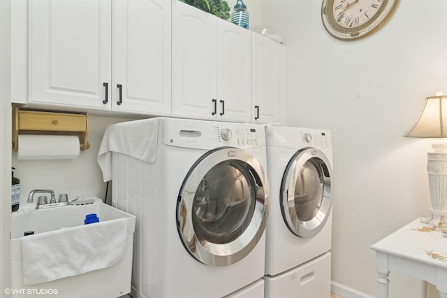 washroom with cabinets, separate washer and dryer, and sink