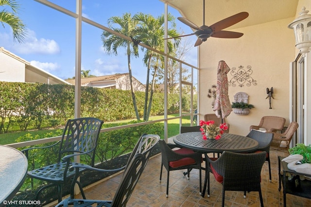 sunroom featuring ceiling fan