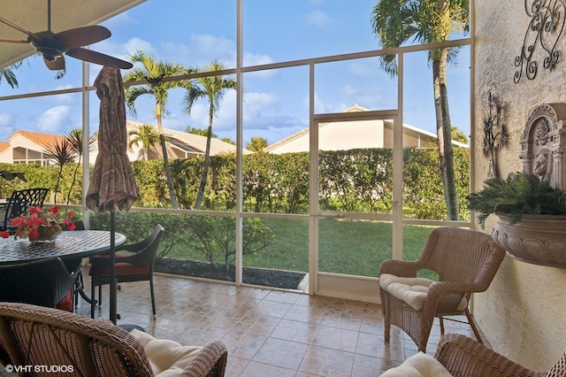 sunroom featuring ceiling fan