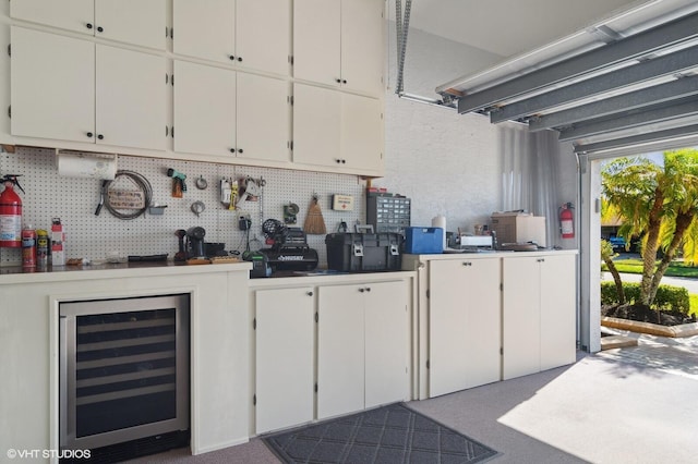 garage featuring a workshop area and beverage cooler