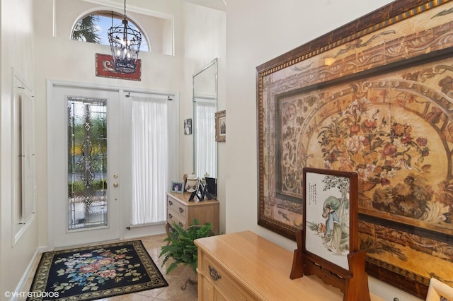 foyer with a chandelier and light tile patterned floors