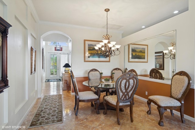 dining area with crown molding and french doors