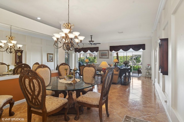 dining space featuring ceiling fan with notable chandelier and ornamental molding