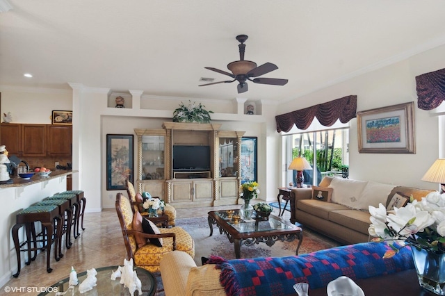 living room with ceiling fan and crown molding