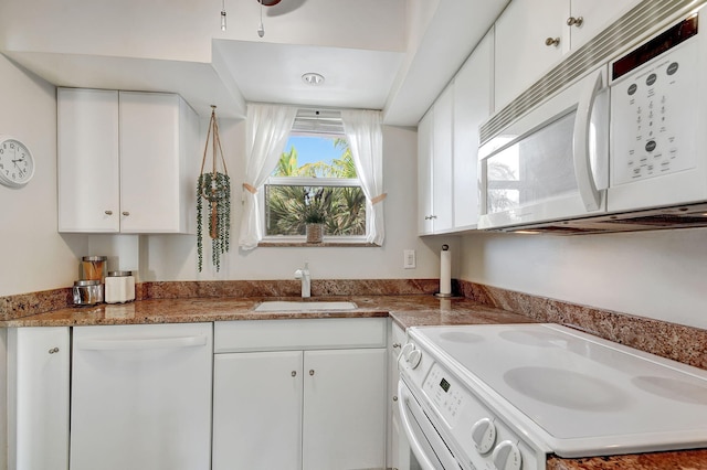 kitchen with white cabinetry, sink, and white appliances