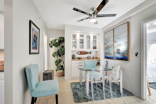 tiled dining space with ceiling fan