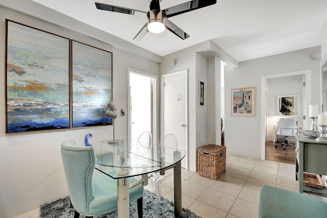 dining space with ceiling fan and light tile patterned flooring