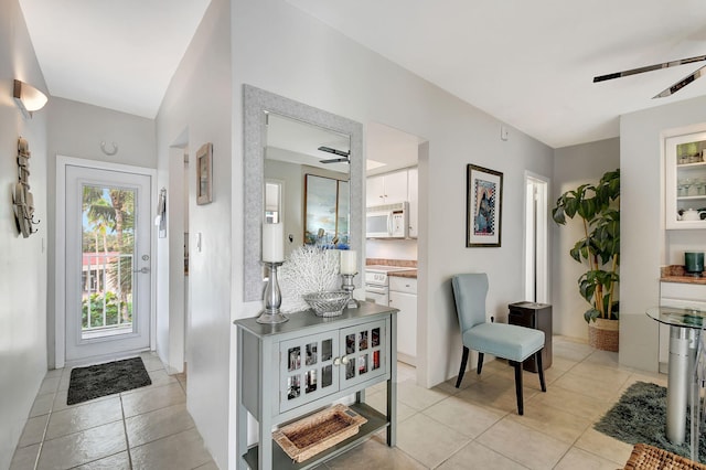 tiled entrance foyer featuring ceiling fan