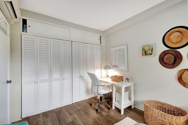 office space with a wall unit AC and dark hardwood / wood-style flooring