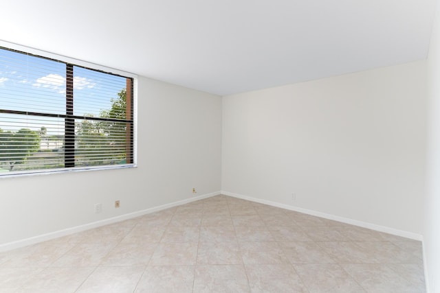 unfurnished room with light tile patterned flooring