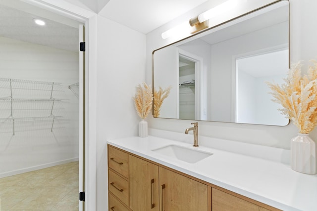 bathroom with tile patterned flooring and vanity