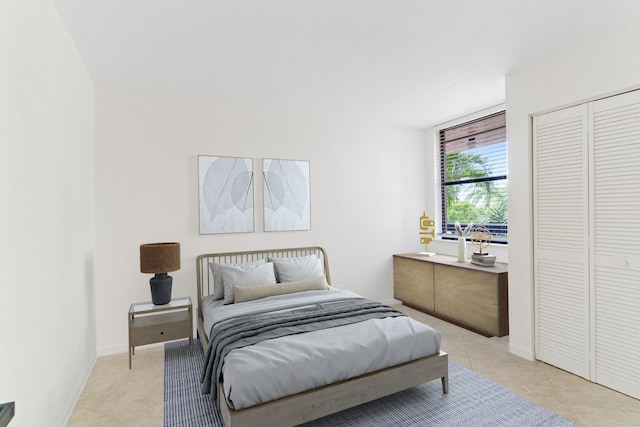 bedroom featuring a closet and light tile patterned flooring