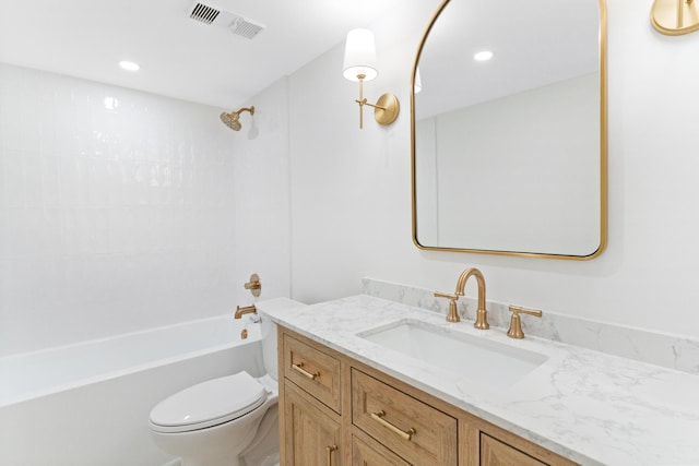 full bathroom featuring vanity, tiled shower / bath combo, and toilet