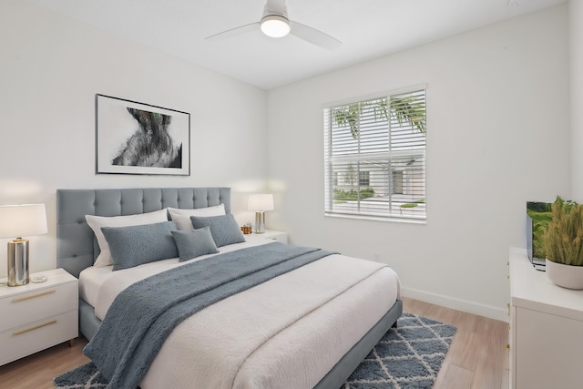 bedroom with ceiling fan and light hardwood / wood-style floors