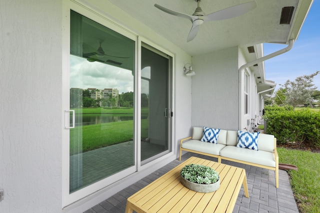 balcony with an outdoor living space, a water view, and a patio area