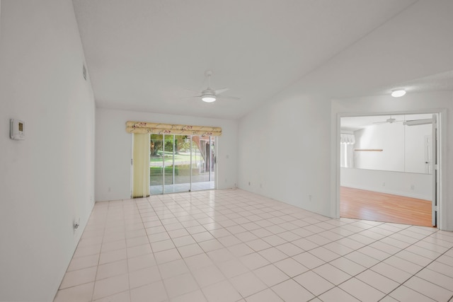 tiled spare room featuring ceiling fan