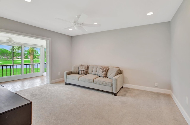 carpeted living room with ceiling fan