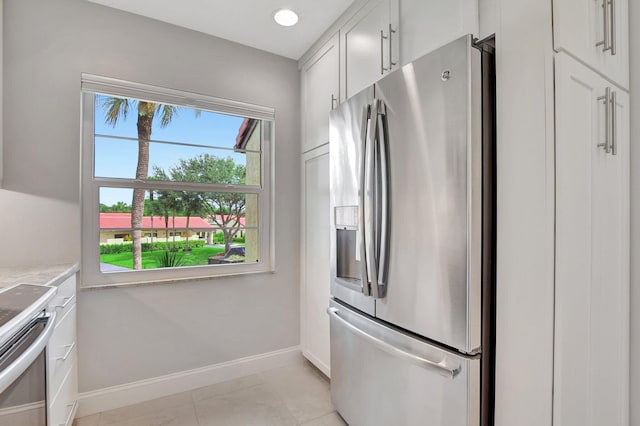 kitchen featuring white cabinetry, light tile patterned floors, and stainless steel appliances