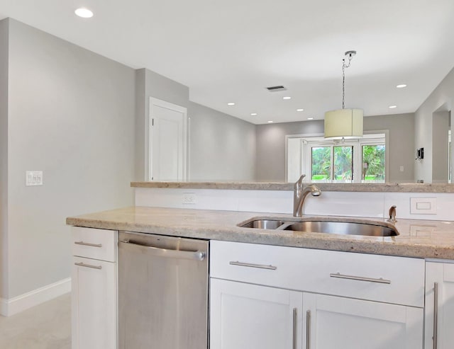 kitchen with stainless steel dishwasher, white cabinets, sink, and pendant lighting