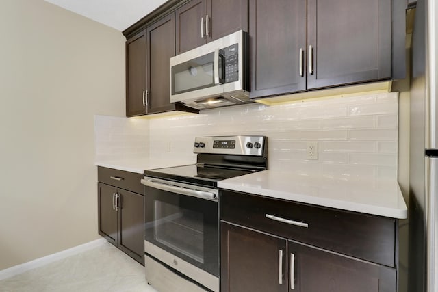 kitchen with light tile patterned floors, appliances with stainless steel finishes, backsplash, and dark brown cabinetry