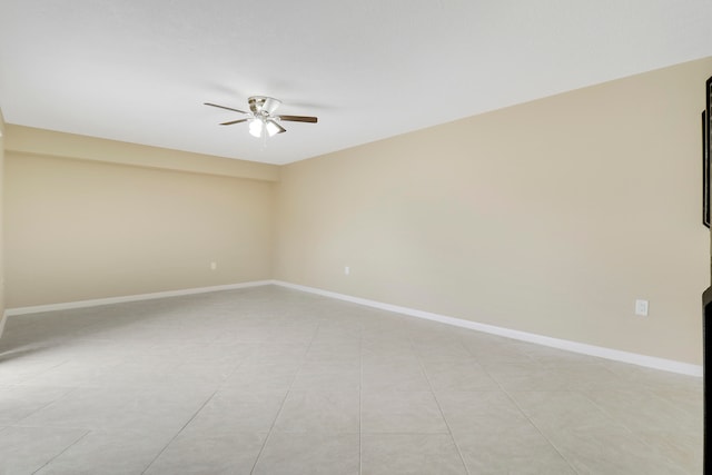 spare room featuring ceiling fan and light tile patterned flooring