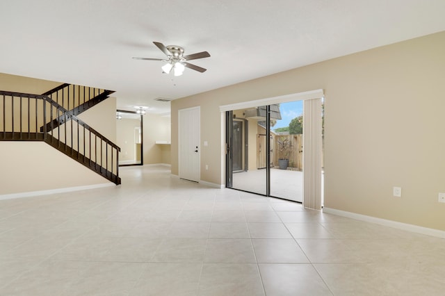 tiled spare room with ceiling fan