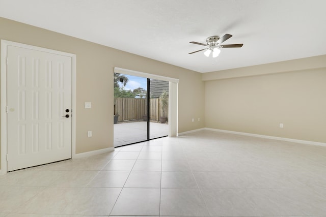 tiled empty room with ceiling fan