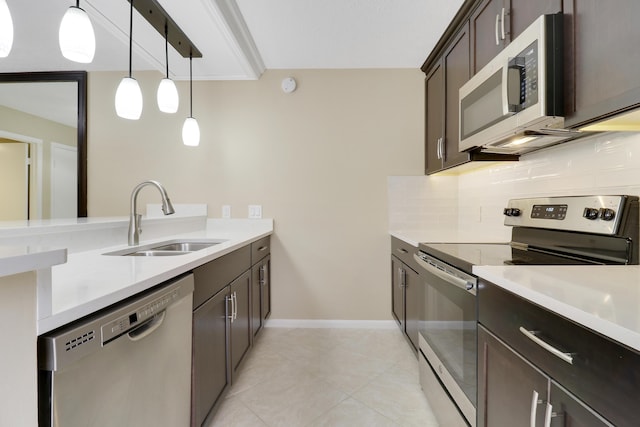 kitchen featuring decorative light fixtures, stainless steel appliances, sink, decorative backsplash, and dark brown cabinetry